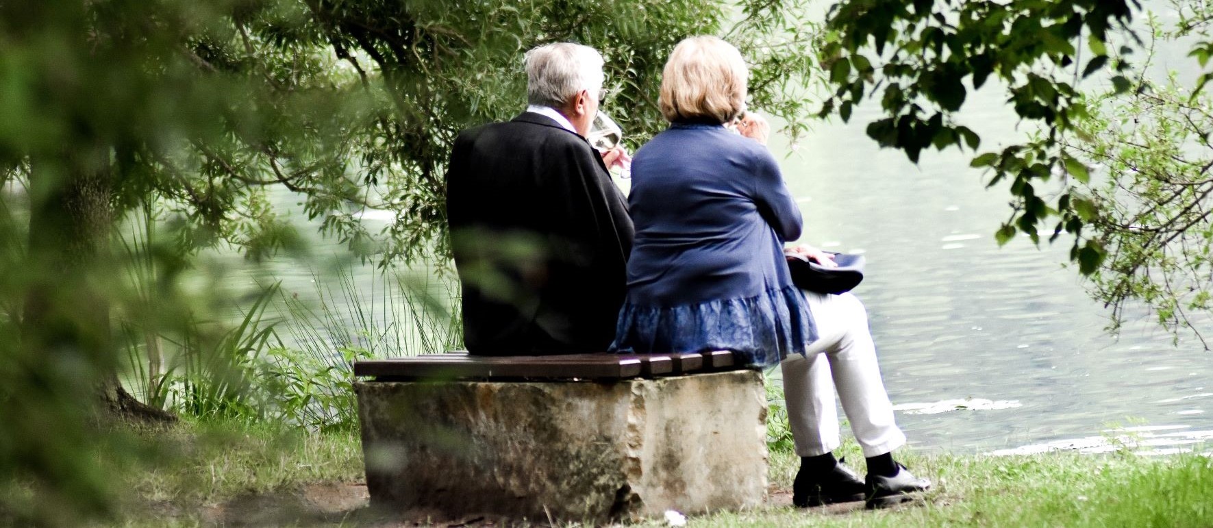 elderly couple by a lake 